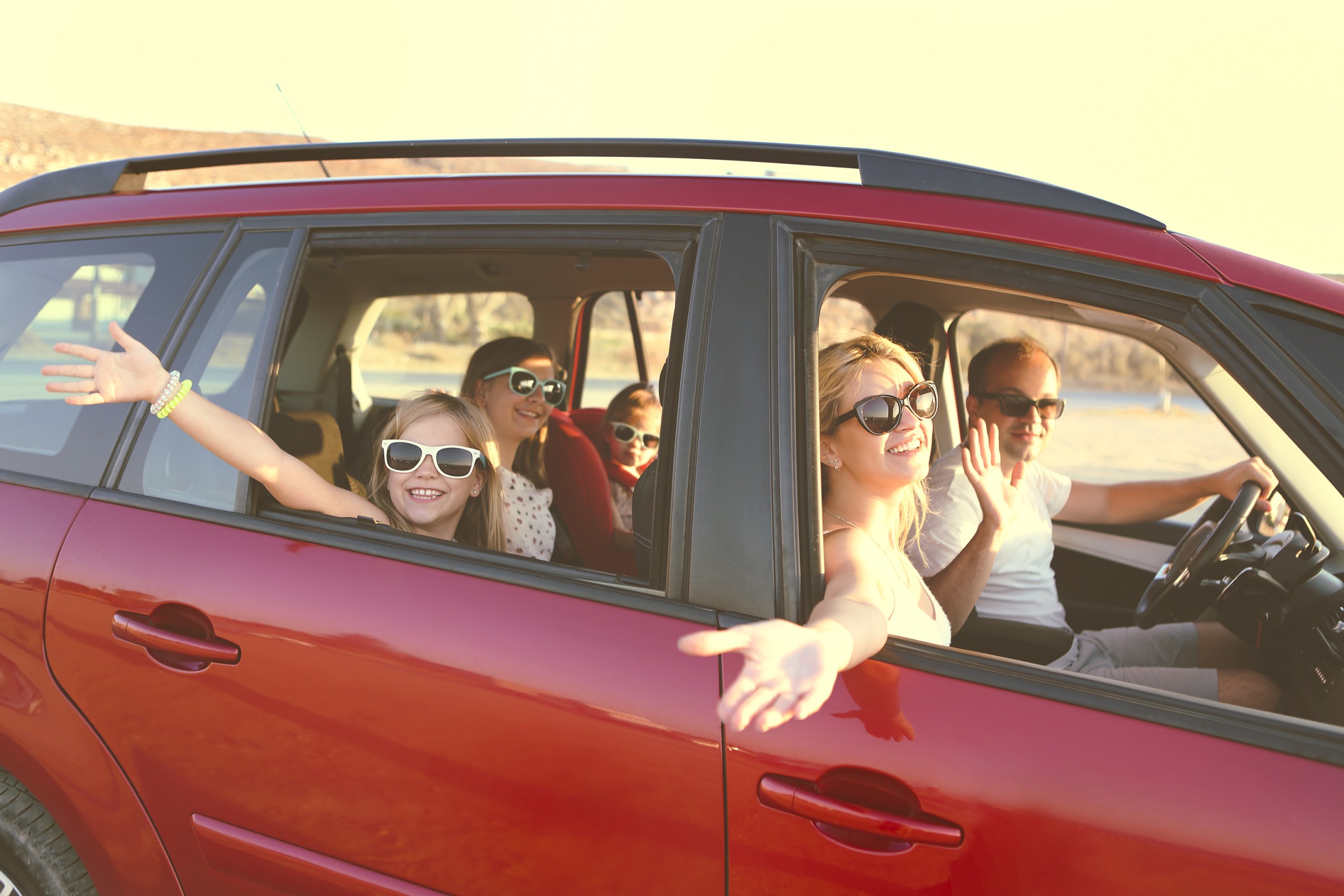 Happy Smiling Family With Daughters In The Car With Sea Background