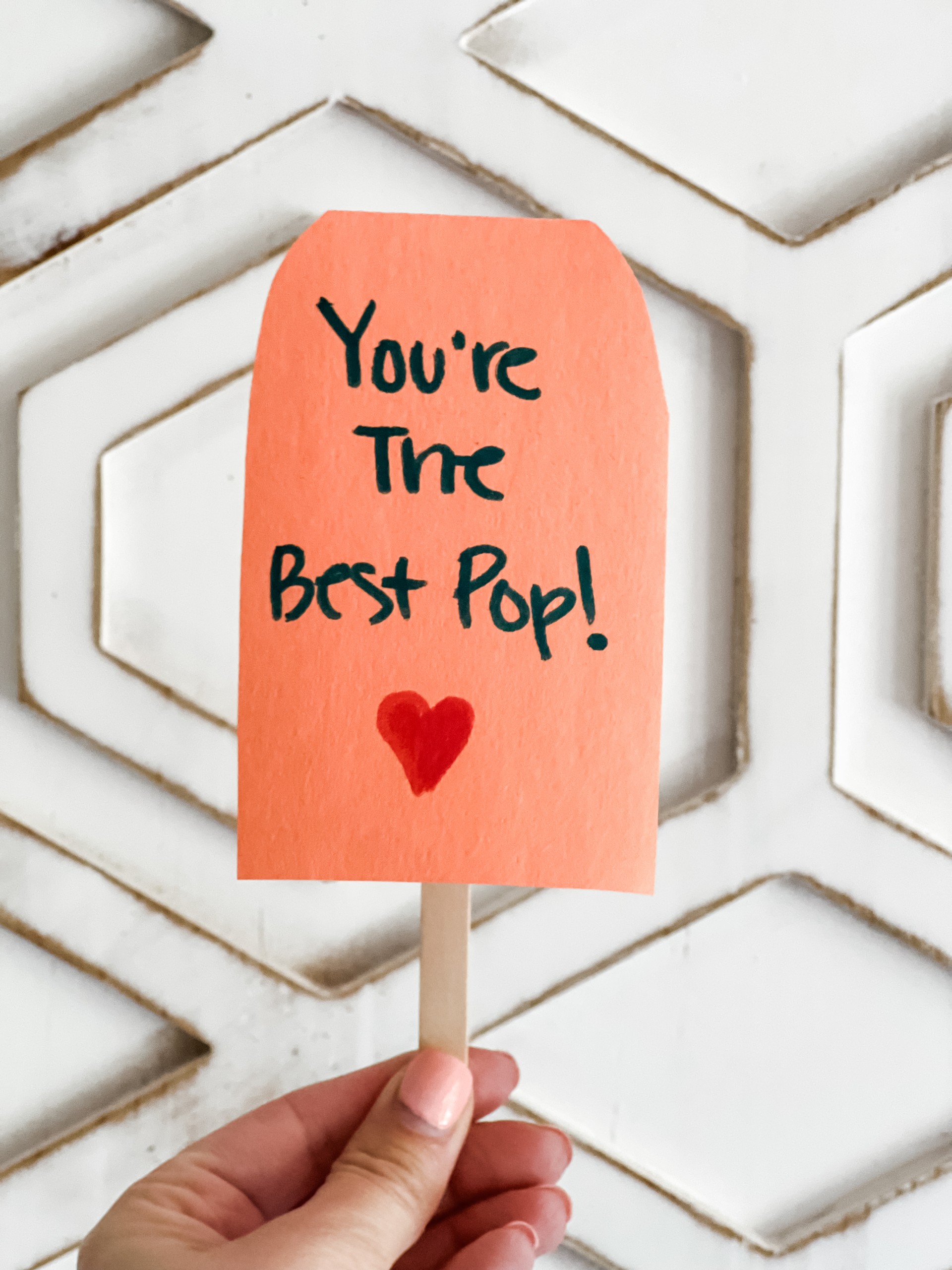 A card on a popsicle stick.