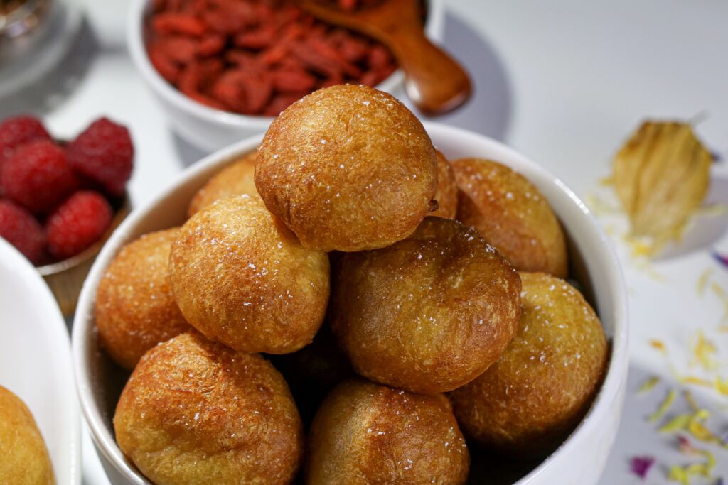A bowl of fried balls of dough representing the many fried carnival treats one could make at home