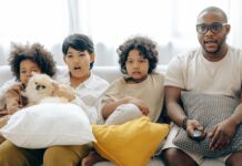 Movie Night: 5 Independence Day Favorites for the Whole Family Happy family watching a movie together | Image by Ketut Subiyanto via Pexels