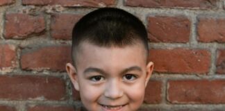 Young boy holds Star Wars plushies