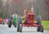 Tractors driving down a road
