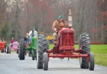 Tractors driving down a road