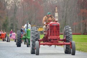Tractors driving down a road
