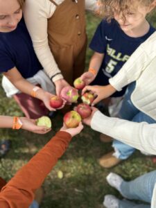 People holding apples together