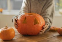 Person carving a pumpkin