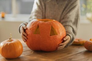 Person carving a pumpkin