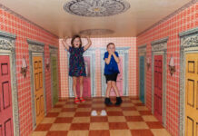 Children in a room in the Please Touch Museum designed to make them look really big