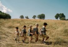 children hiking through a field