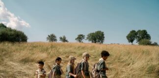 children hiking through a field