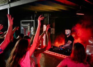 Kids dancing in front of a DJ