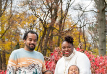 A family standing in front of some trees