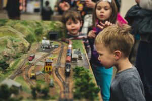 Kids looking at a model train set