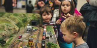 Kids looking at a model train set