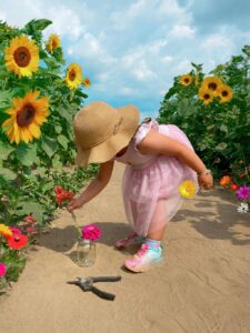 A little girl in a field of sunflowers