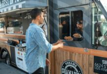 Man getting hot dogs from a food truck