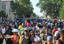 A large crowd with some kids sitting on shoulders at the Juneteenth Parade in Philadelphia