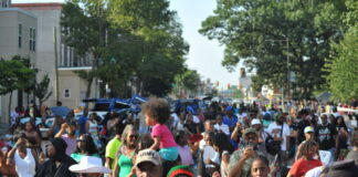 A large crowd with some kids sitting on shoulders at the Juneteenth Parade in Philadelphia