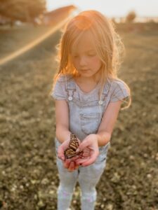 Young girl holding a butterfly