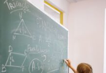 A girl doing math on a blackboard