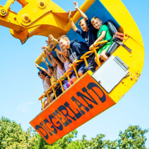 People riding a construction equipment-themed ride at Diggerland USA