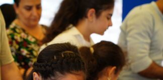 Girl reading a book at a book sale